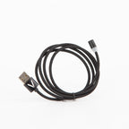 Black braided magnetic USB cable for the VOID lid, coiled on a white background