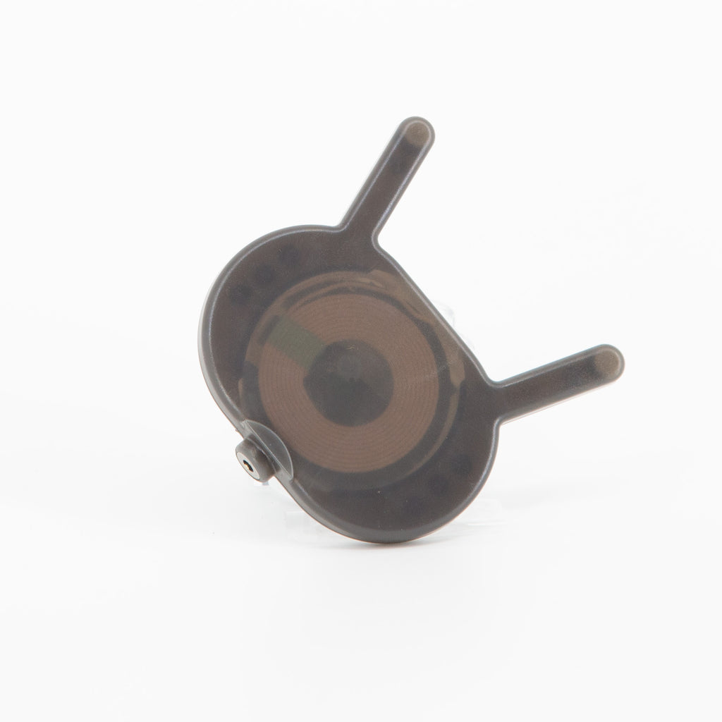 VOID wireless charger, a smoky translucent pad with two arms and a visible charging coil