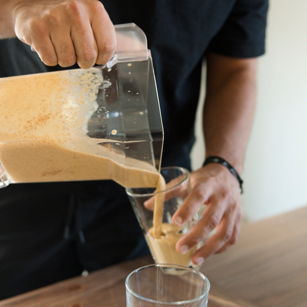 Pouring a smoothie from the VOID jar into a glass